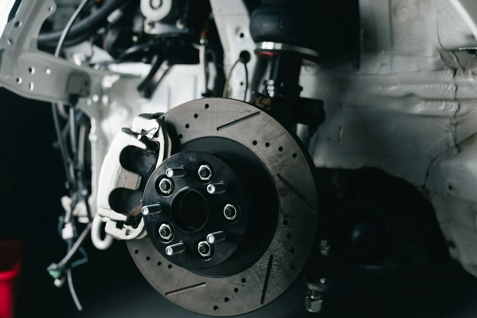 Drilled brake disc and caliper on a car