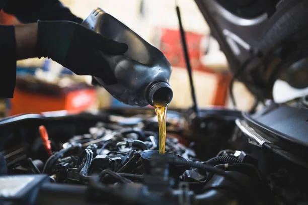 Fresh engine oil being poured into an engine
